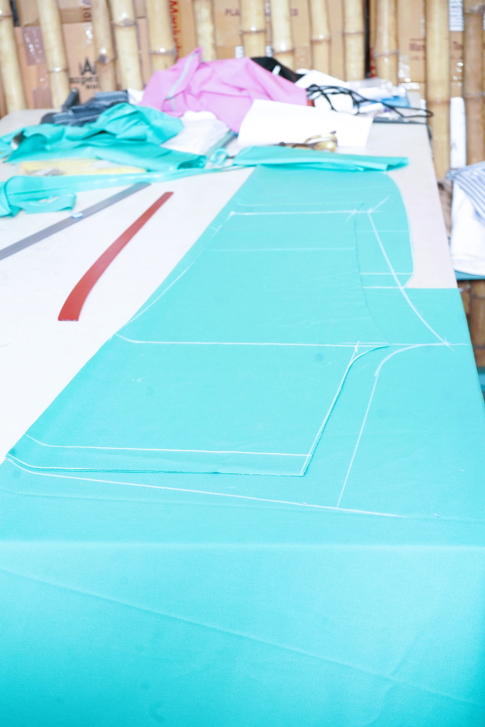 Cloth laid out and chalked on the cutting table
