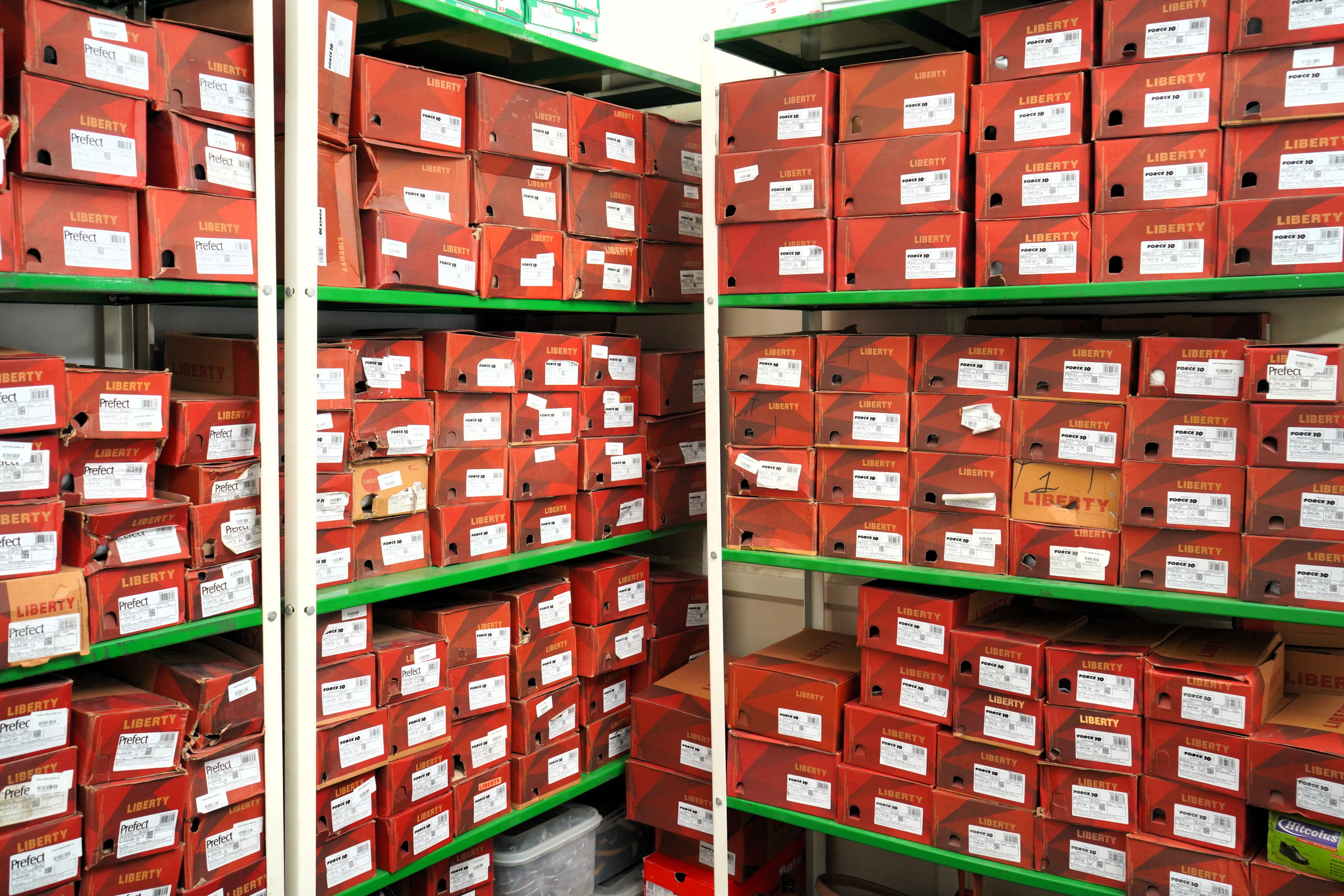 Boxed school shoes racked to the ceiling at Kharar